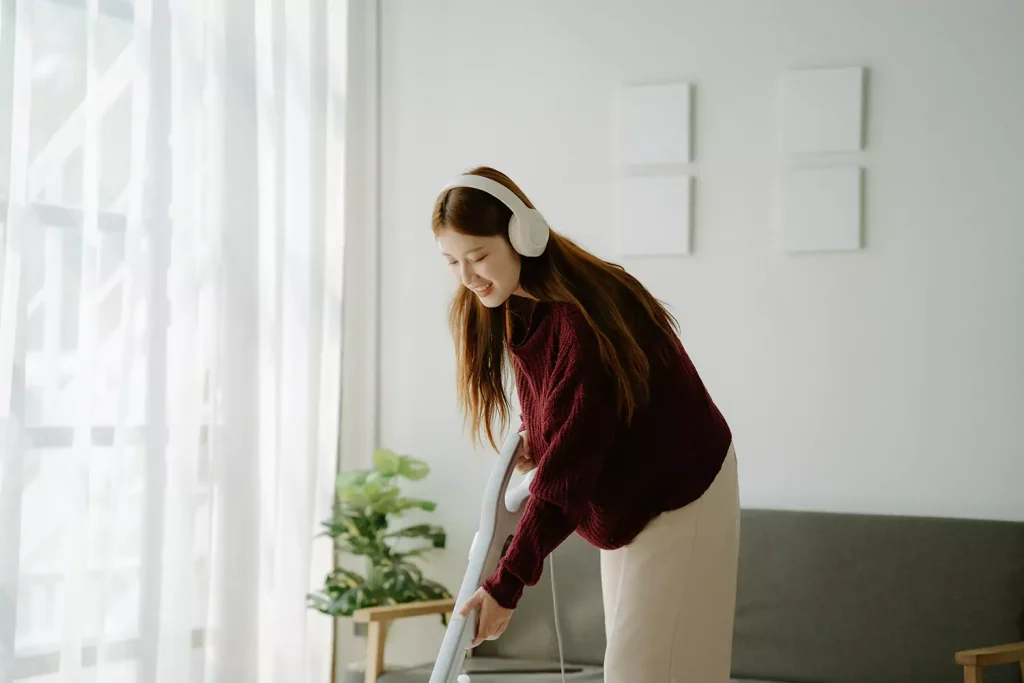 Woman vacuuming home